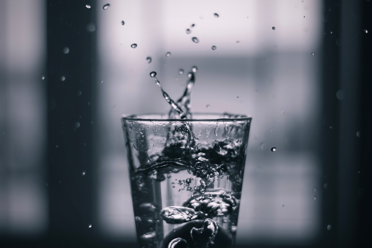 Person measuring water intake during daily activities